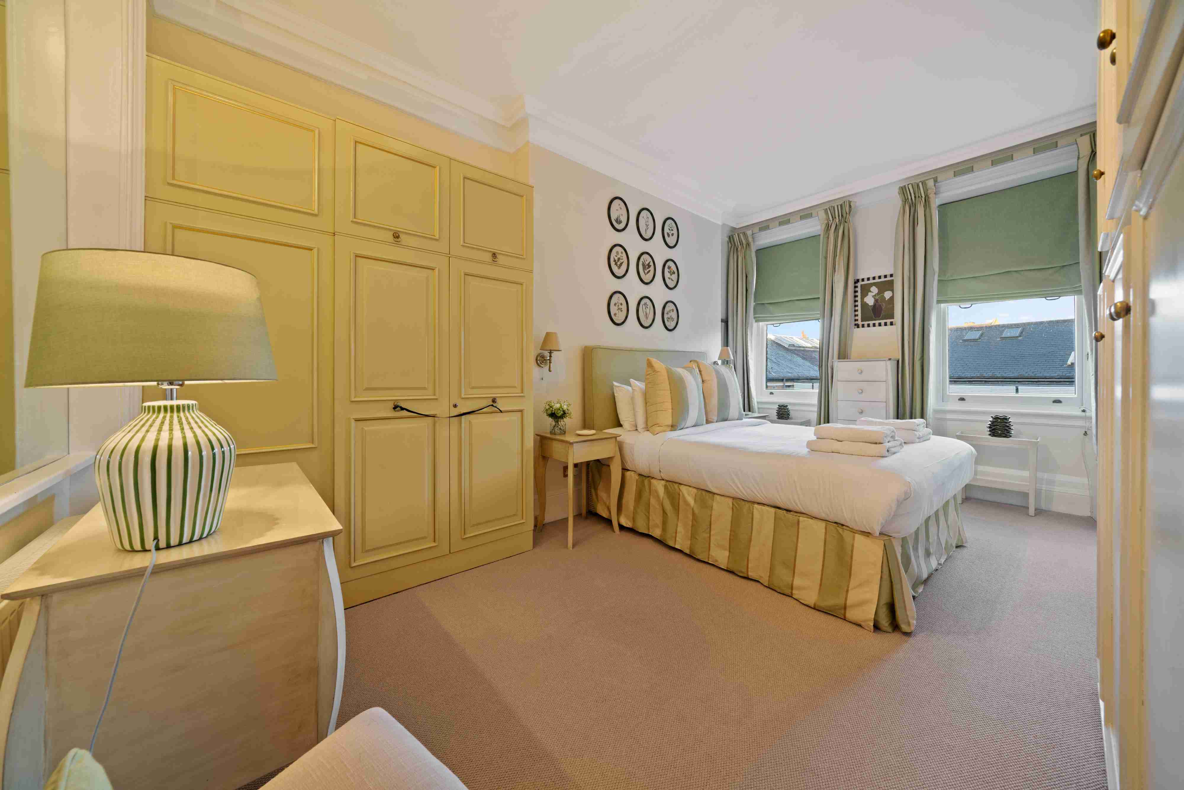 Warm London apartment bedroom with classic charm